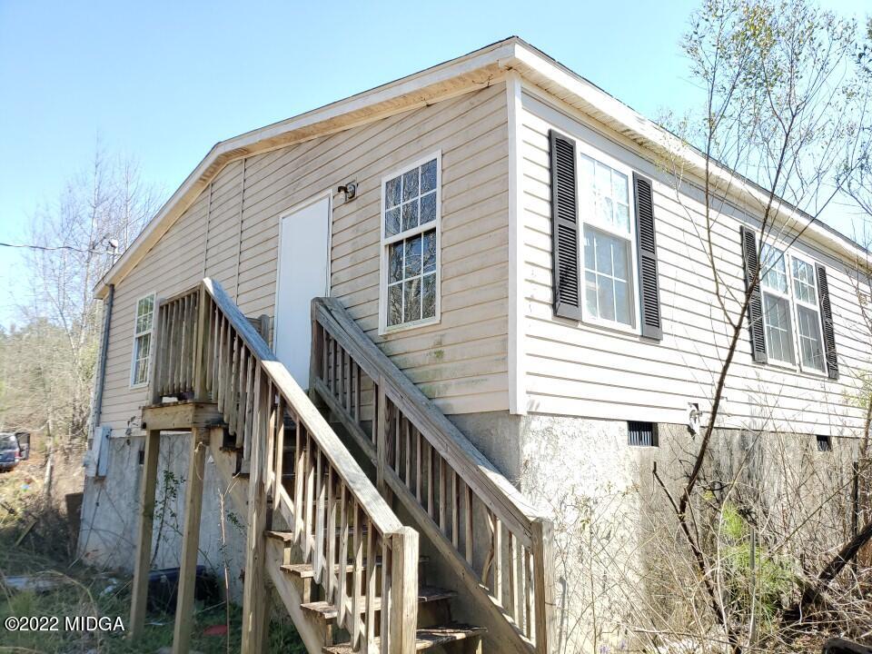 2755 Tribble Road Fort Valley, GA 31030 - Photo 3 of 10 a view of a house with wooden fence