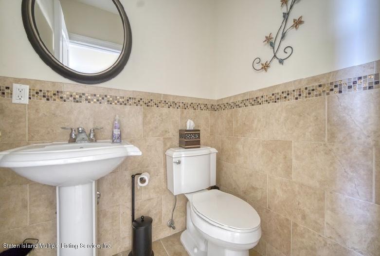47 Brookside Loop Staten Island, NY 10309 - Photo 11 of 26 a bathroom with a sink a mirror a toilet and a mirror