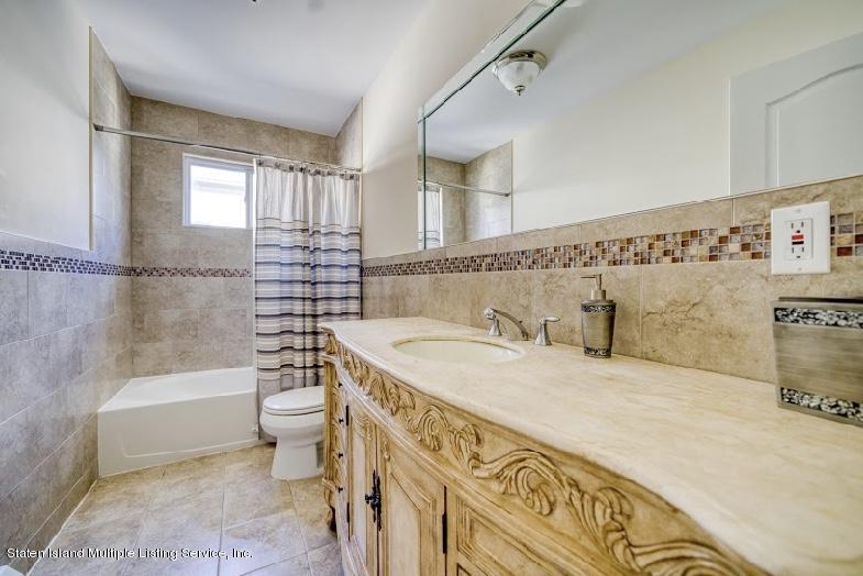 47 Brookside Loop Staten Island, NY 10309 - Photo 15 of 26 a bathroom with a granite countertop bathtub sink vanity mirror and toilet