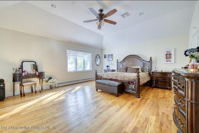 47 Brookside Loop Staten Island, NY 10309 - Photo 16 of 26 a bedroom with a bed wooden floor and a window