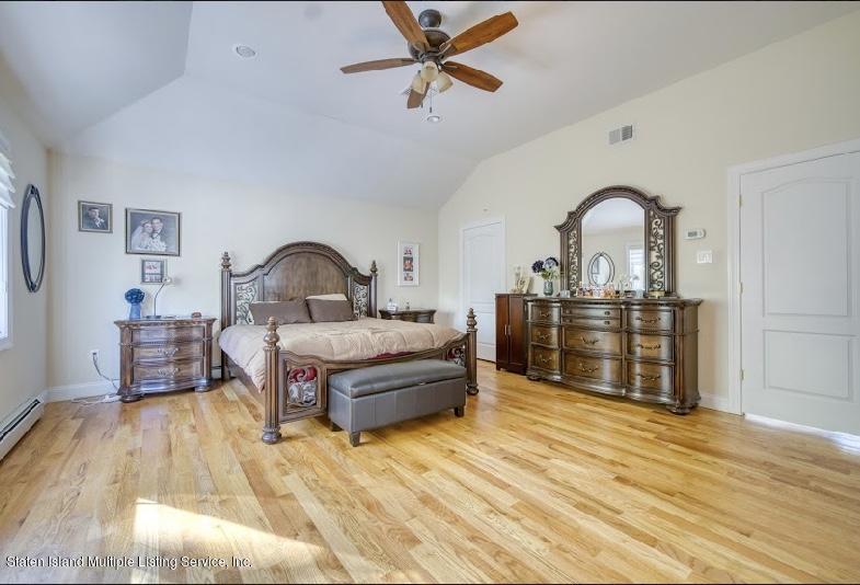 47 Brookside Loop Staten Island, NY 10309 - Photo 17 of 26 a bedroom with furniture and a wooden floor