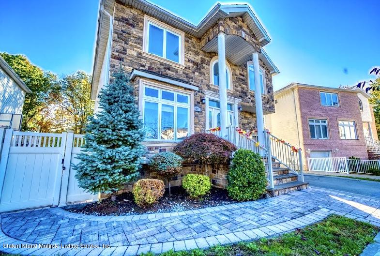 47 Brookside Loop Staten Island, NY 10309 - Photo 2 of 26 a view of a brick building next to a yard