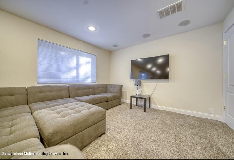 47 Brookside Loop Staten Island, NY 10309 - Photo 21 of 26 a living room with couches and a flat screen tv