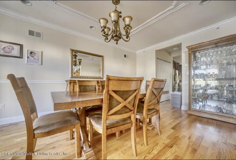 47 Brookside Loop Staten Island, NY 10309 - Photo 4 of 26 a view of a dining room with furniture and chandelier