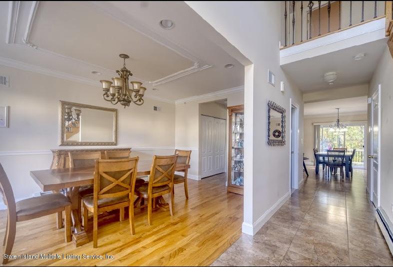 47 Brookside Loop Staten Island, NY 10309 - Photo 5 of 26 a view of a dining room with furniture and chandelier