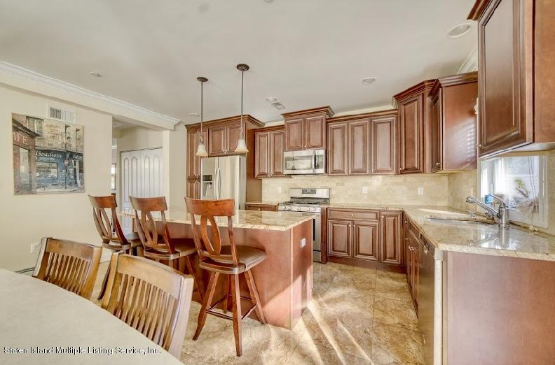 47 Brookside Loop Staten Island, NY 10309 - Photo 8 of 26 a open kitchen with stainless steel appliances granite countertop a stove a sink dishwasher and a refrigerator with cabinets