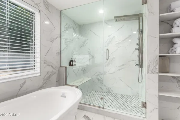 a bathroom with a bathtub and a shower