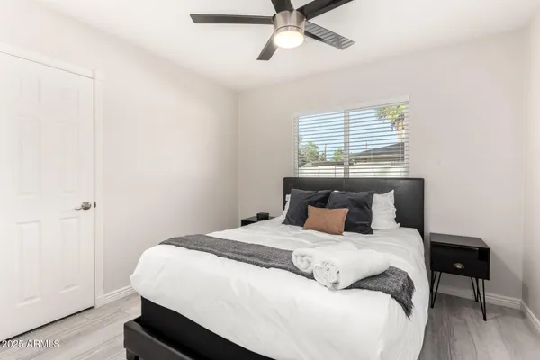 a bedroom with a bed and wooden floor