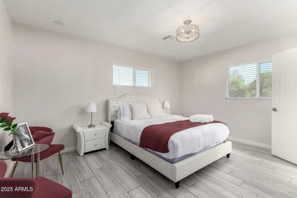 a bedroom with a bed and chair