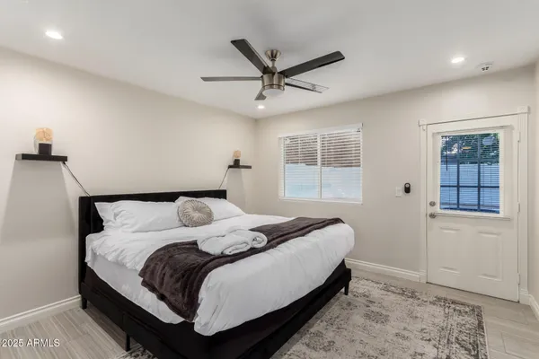 a bedroom with a large bed and a window