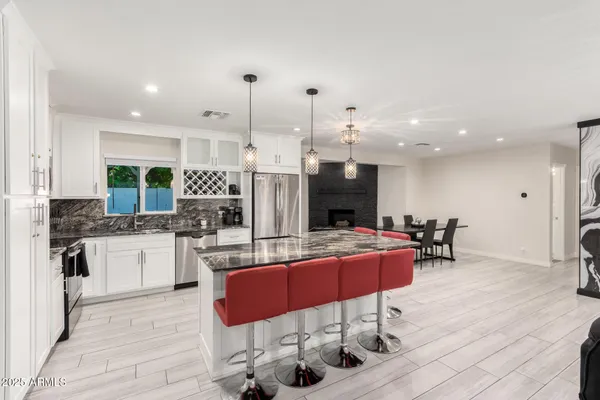a kitchen with stainless steel appliances kitchen island granite countertop a sink and cabinets