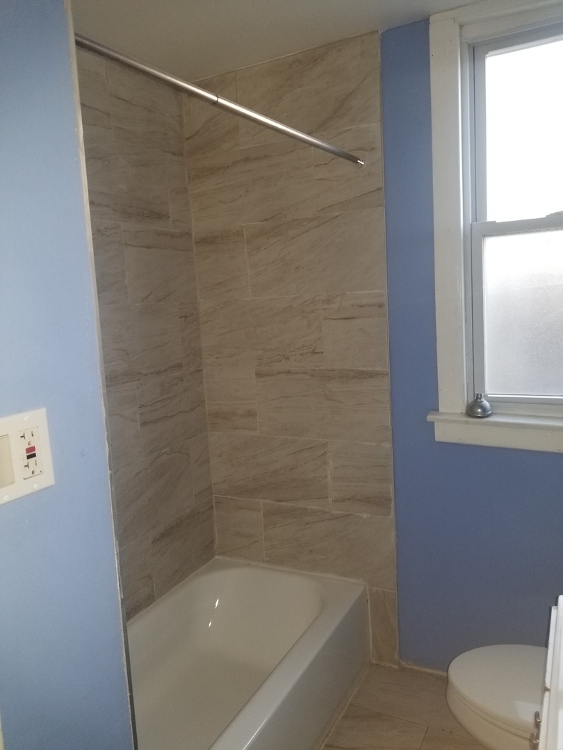 2453 West 46th Place, Unit 1 Chicago, IL 60632 - Photo 11 of 13 a bathroom with a shower and toilet