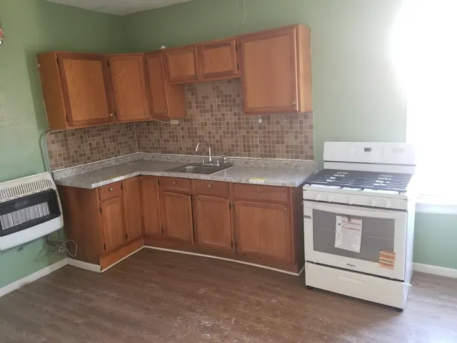 a kitchen with a sink stove and cabinets
