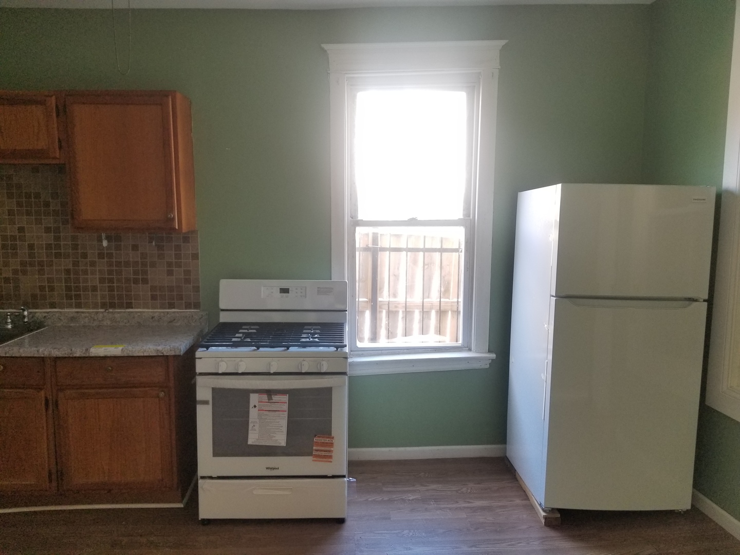 2453 West 46th Place, Unit 1 Chicago, IL 60632 - Photo 7 of 13 a kitchen with a refrigerator sink and stove