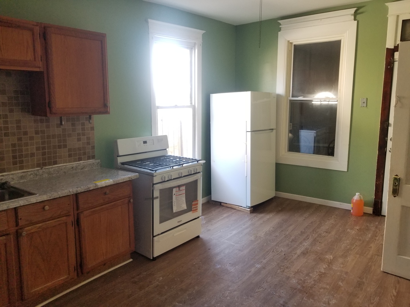 2453 West 46th Place, Unit 1 Chicago, IL 60632 - Photo 8 of 13 a kitchen with a refrigerator sink and cabinets
