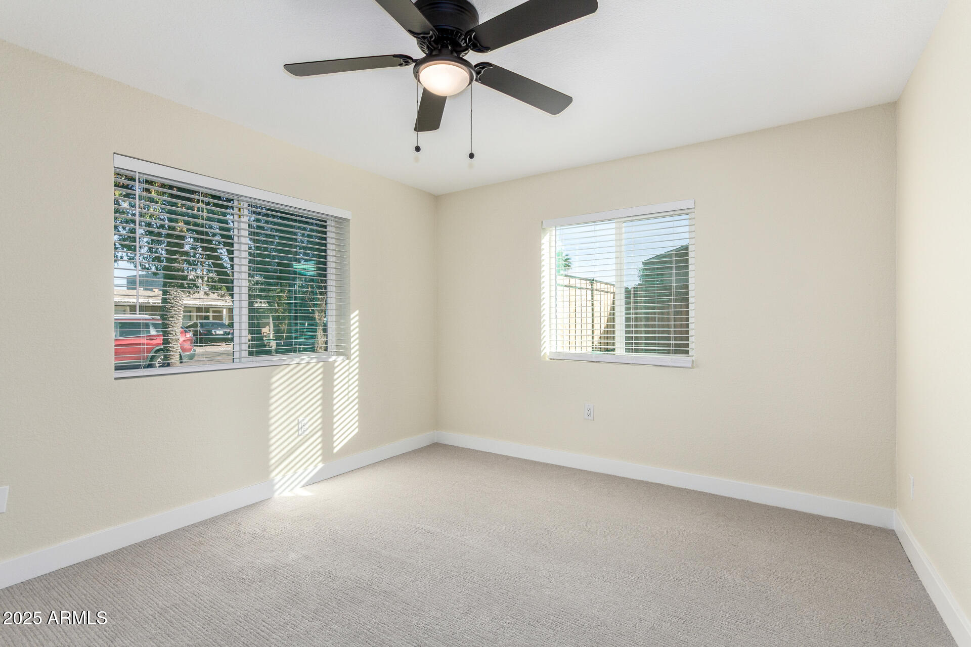 2749 West Montecito Avenue Phoenix, AZ 85017 - Photo 13 of 20 an empty room with a window and a ceiling fan