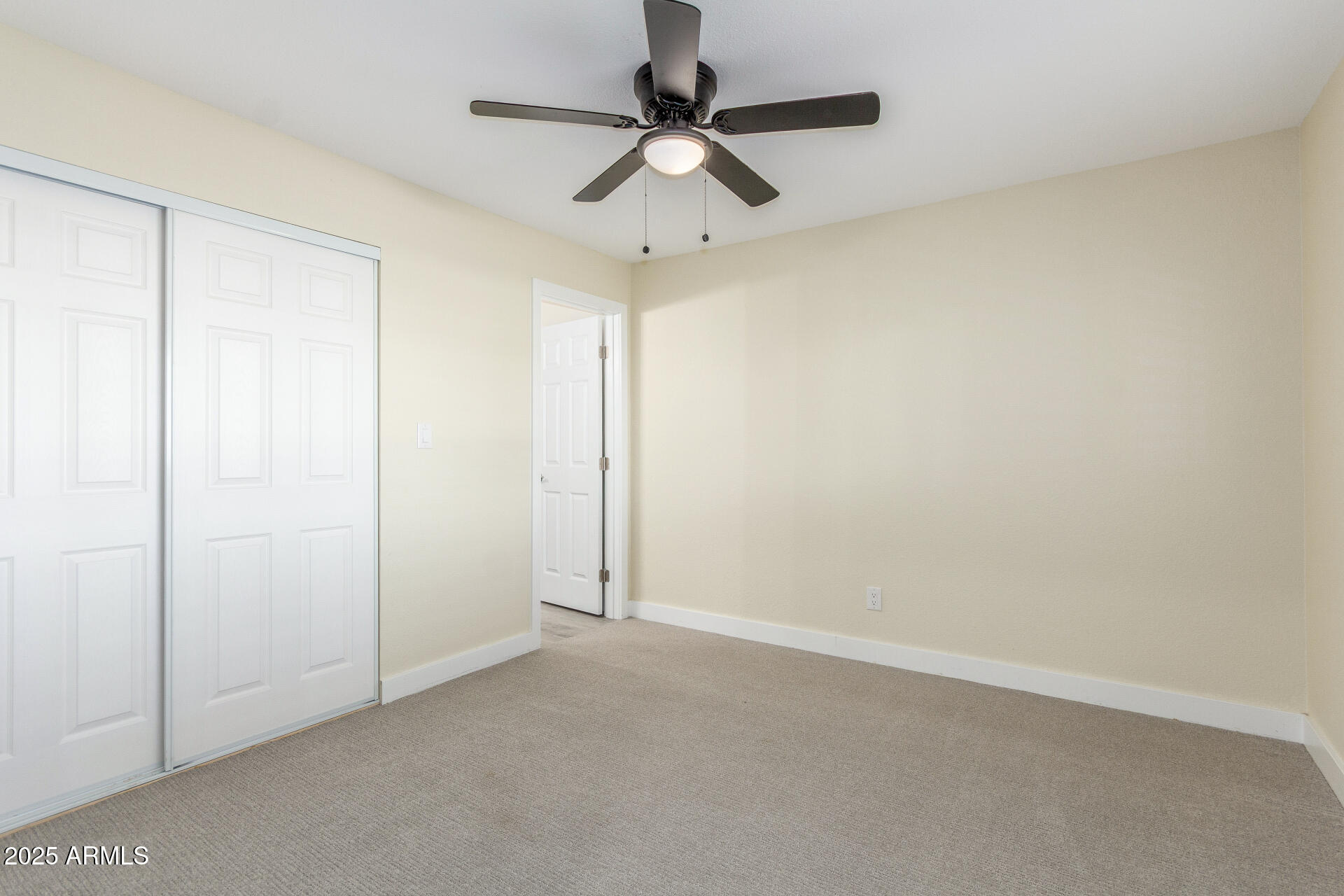 2749 West Montecito Avenue Phoenix, AZ 85017 - Photo 8 of 20 an empty room with a ceiling fan and carpet