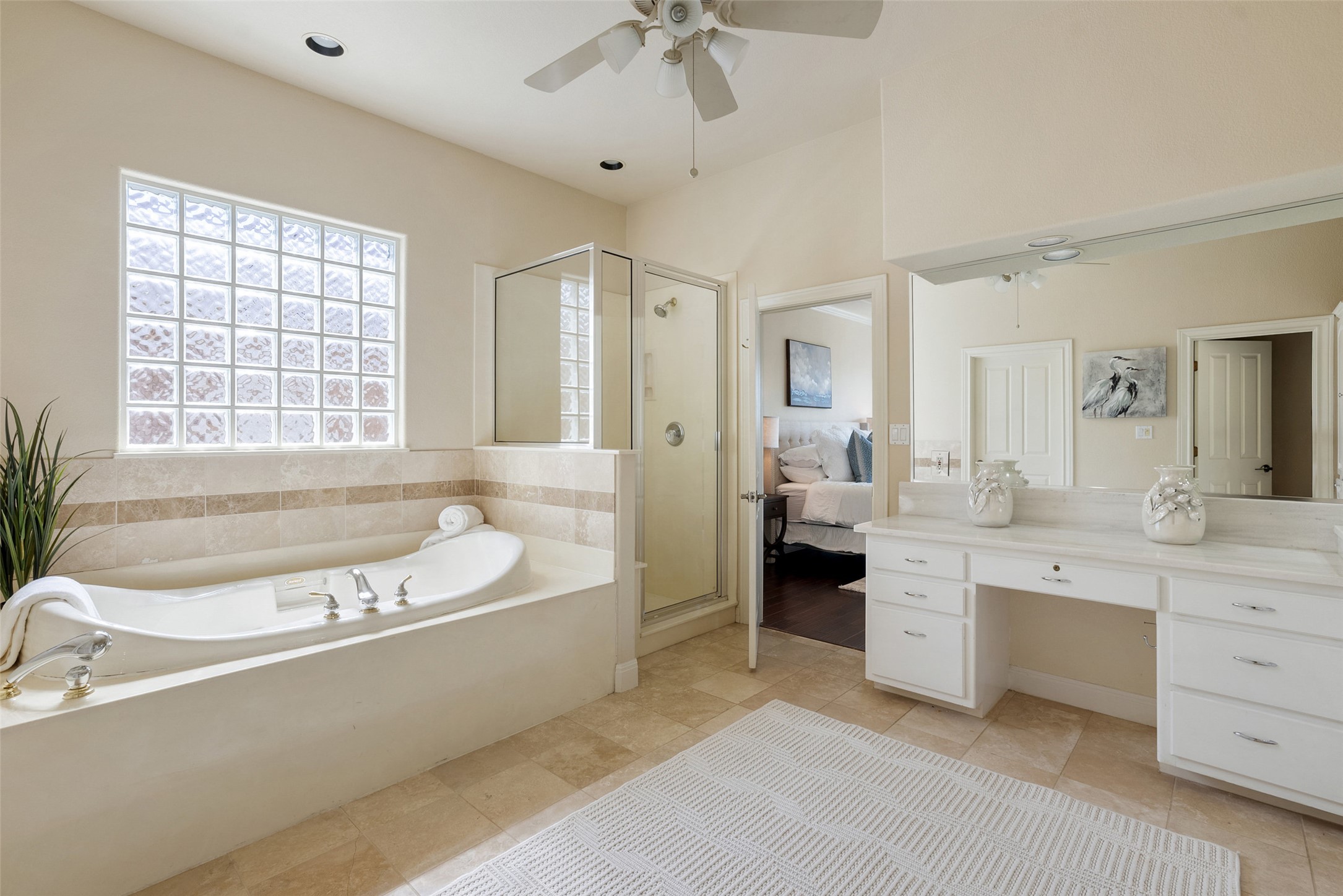316 Lakefront Drive Point Venture, TX 78645 - Photo 19 of 40 a spacious bathroom with a tub sink double vanity and windows