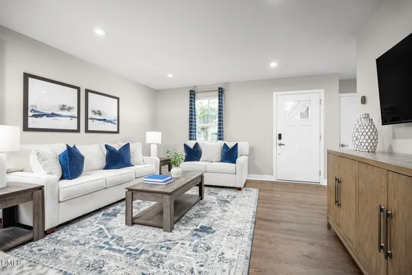 a dining room with furniture a large window and stainless steel appliances