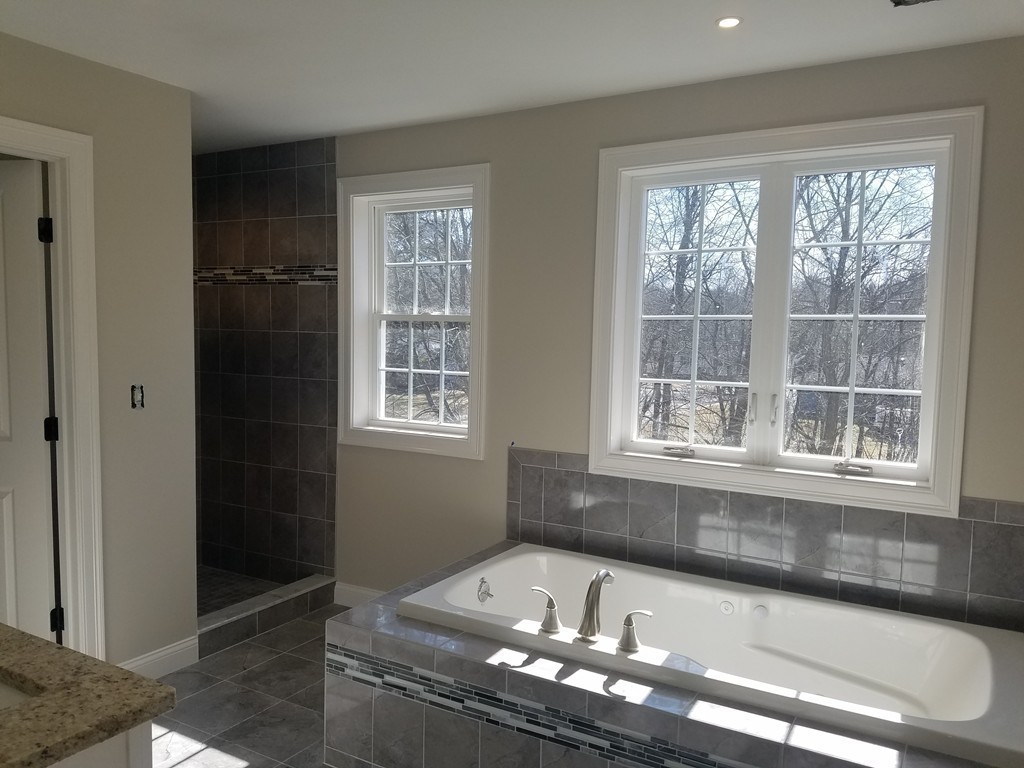 8 Anthony Road North Reading, MA 01864 - Photo 13 of 28 a bath tub sitting in a bathroom next to a window
