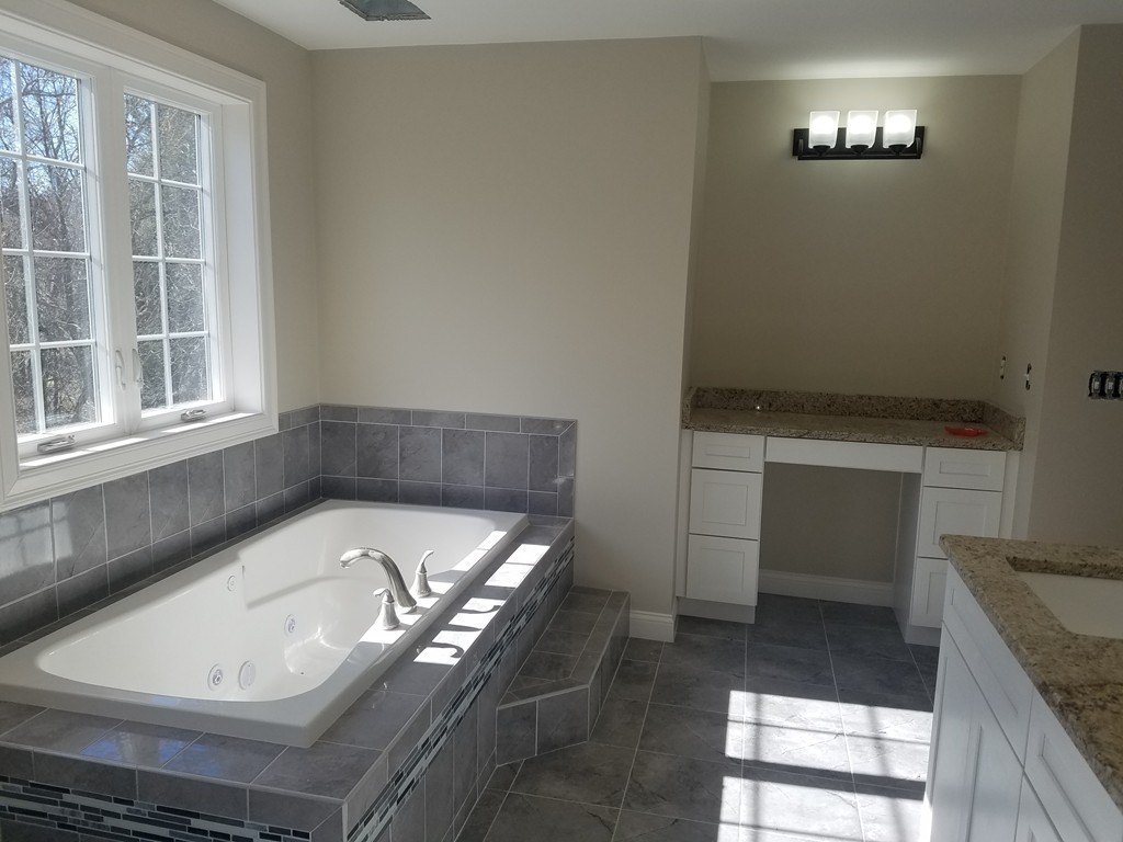 8 Anthony Road North Reading, MA 01864 - Photo 17 of 28 a bathroom with a tub a sink and a stove