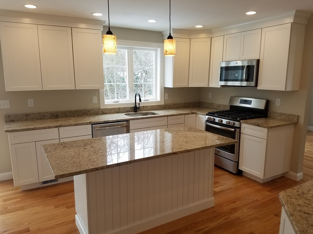 8 Anthony Road North Reading, MA 01864 - Photo 5 of 28 a kitchen with stainless steel appliances granite countertop a stove a sink and a microwave