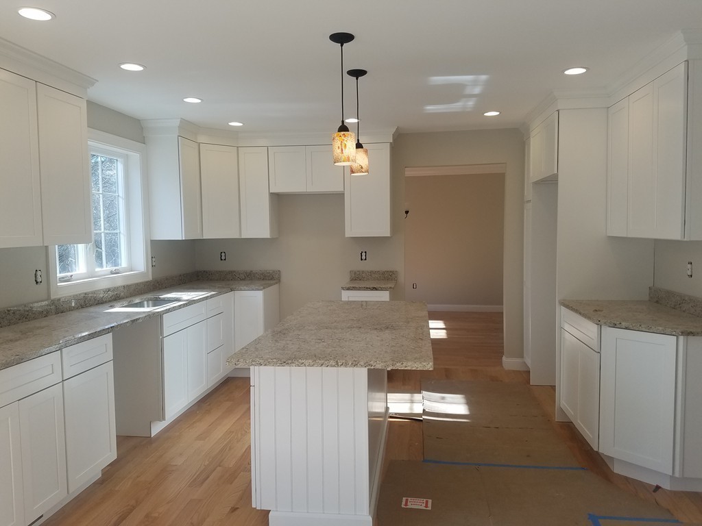 8 Anthony Road North Reading, MA 01864 - Photo 8 of 28 a kitchen with kitchen island granite countertop stainless steel appliances lots of counter top space