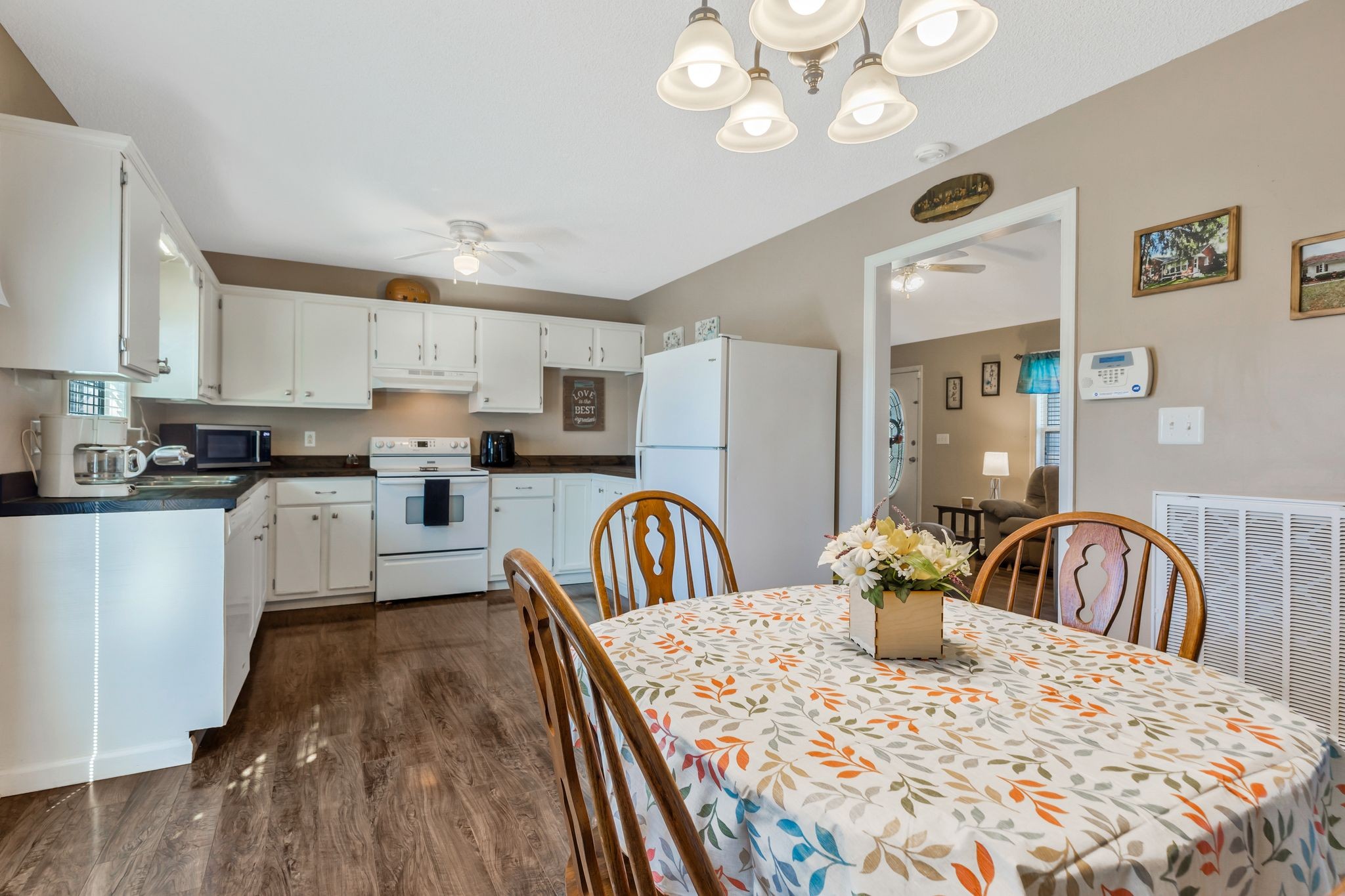 740 Happy Valley Road Bell Buckle, TN 37020 - Photo 13 of 33 a kitchen with granite countertop a stove a sink a dining table and chairs