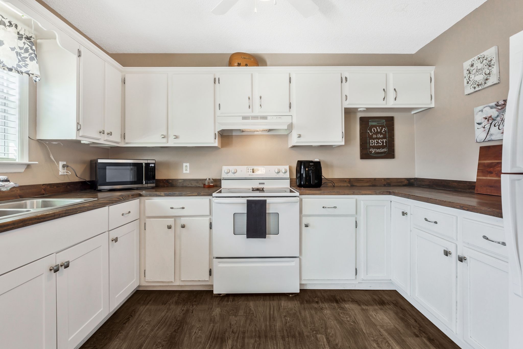 740 Happy Valley Road Bell Buckle, TN 37020 - Photo 14 of 33 a white kitchen with granite countertop white cabinets and white appliances