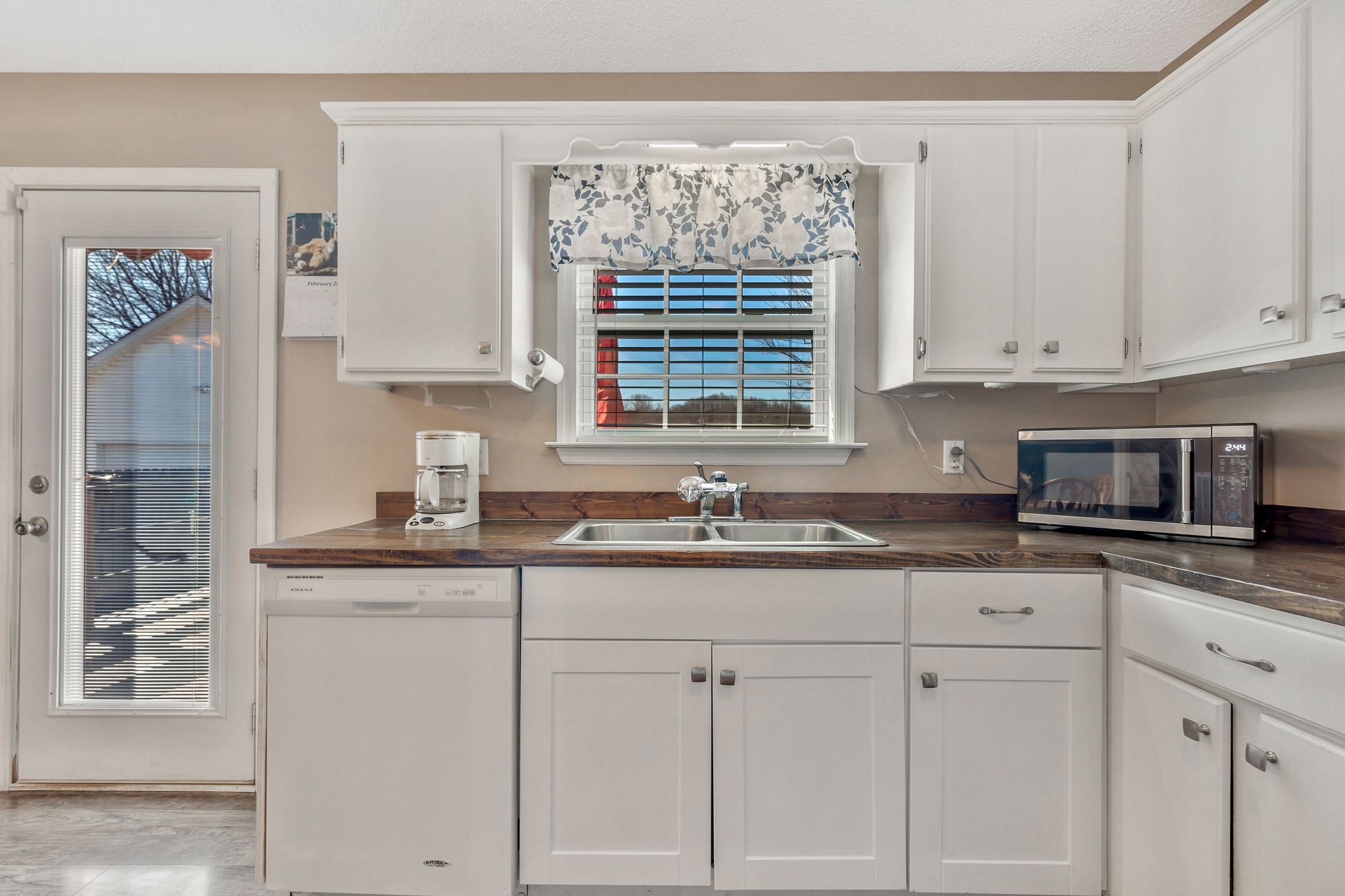 740 Happy Valley Road Bell Buckle, TN 37020 - Photo 15 of 33 a kitchen with granite countertop white cabinets and a sink