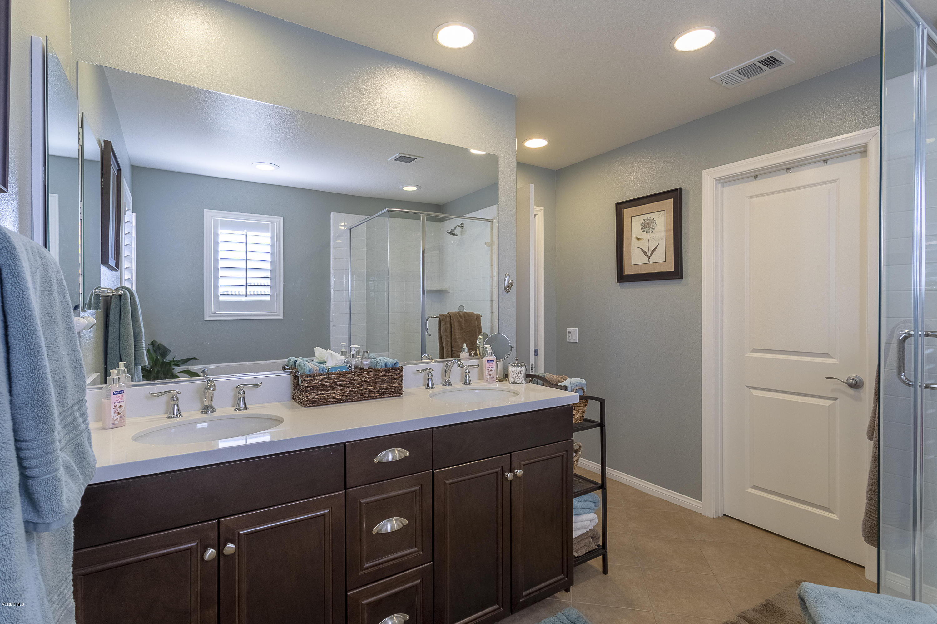 613 Xanadu Way Oxnard, CA 93036 - Photo 14 of 30 a bathroom with a double vanity sink and a mirror