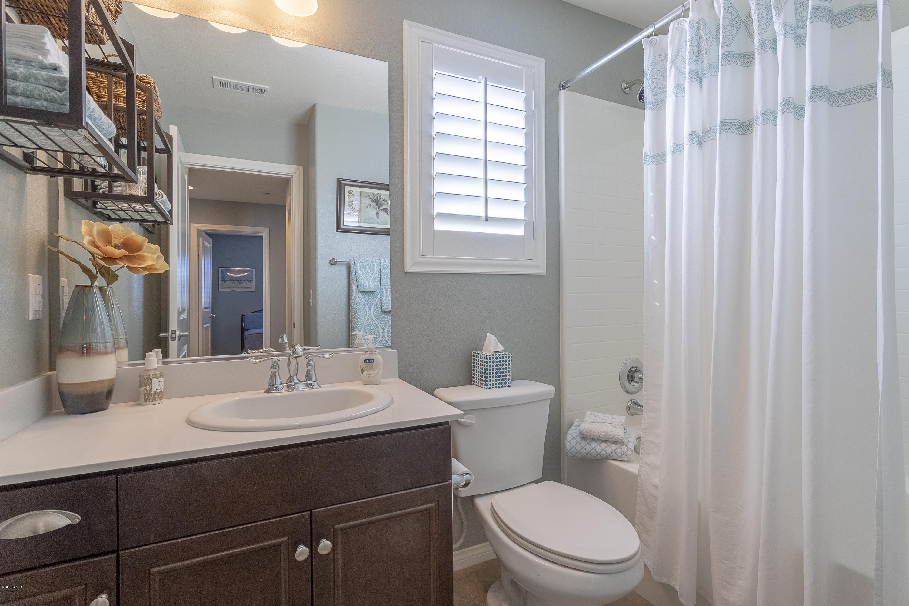 613 Xanadu Way Oxnard, CA 93036 - Photo 16 of 30 a bathroom with a sink a toilet a mirror and shower