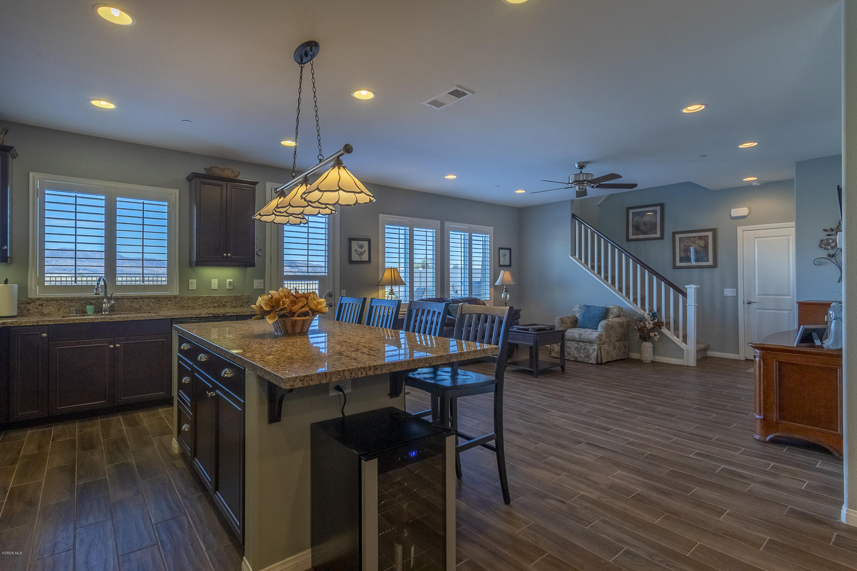 613 Xanadu Way Oxnard, CA 93036 - Photo 8 of 30 a kitchen that has a table chairs in it and wooden floors