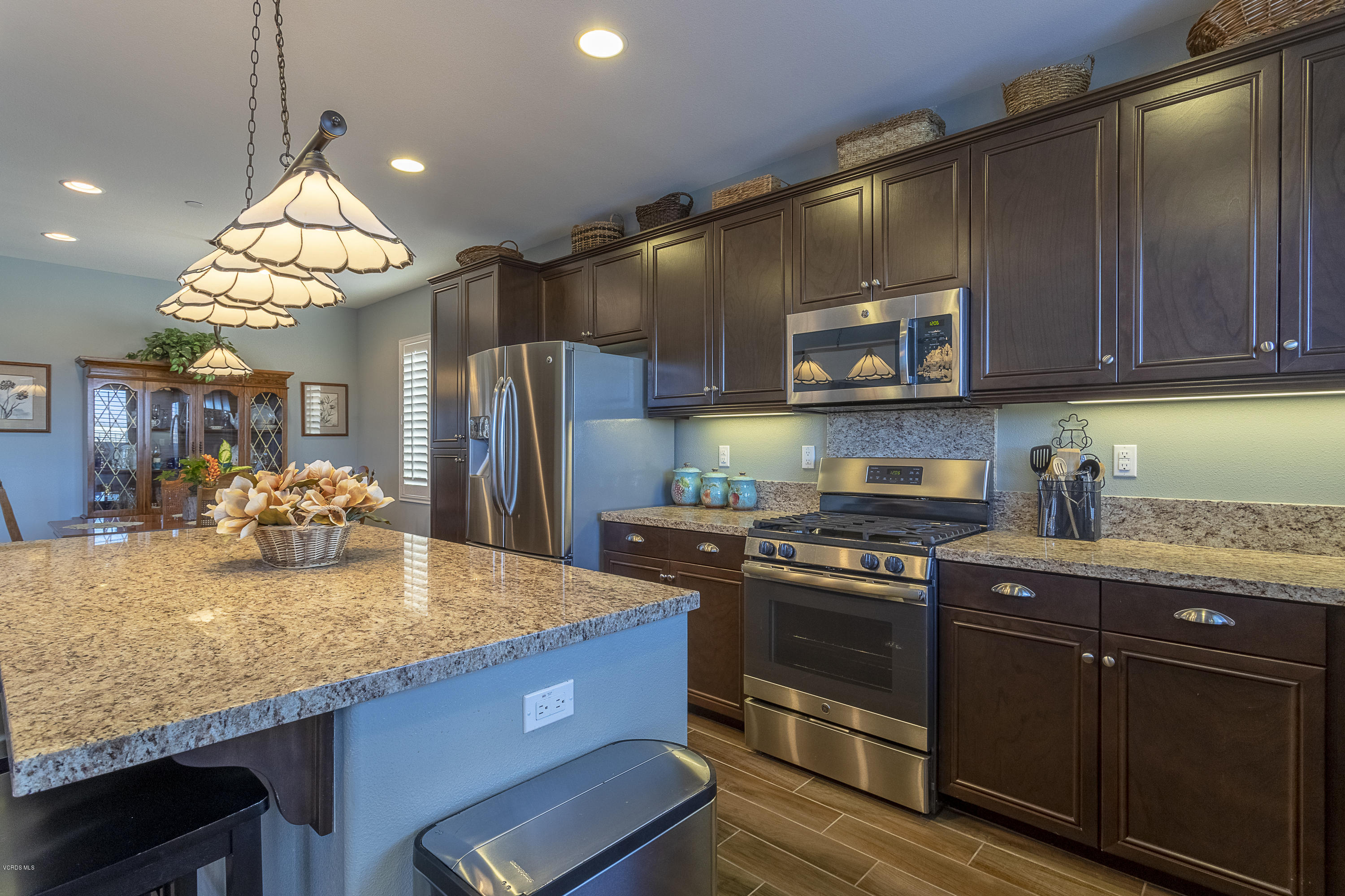 613 Xanadu Way Oxnard, CA 93036 - Photo 9 of 30 a kitchen with stainless steel appliances granite countertop a stove a sink and a refrigerator