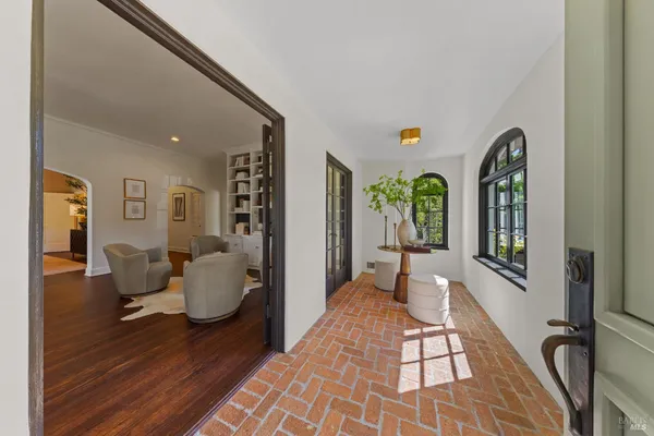 a living room with furniture and a book shelf