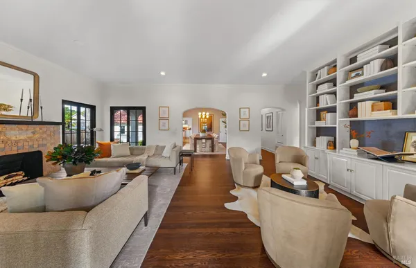 a living room with furniture and a chandelier