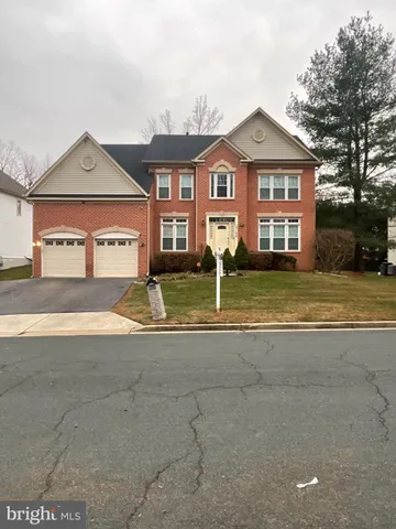 a front view of a house with a yard and a garage