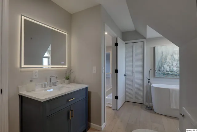 a bathroom with a sink a vanity and a mirror
