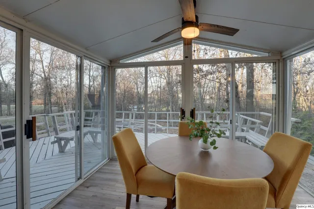 a dining room with furniture window and outside view