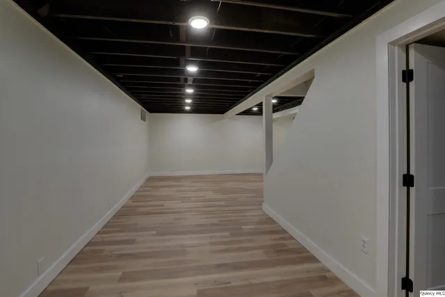 a view of hallway with wooden floor