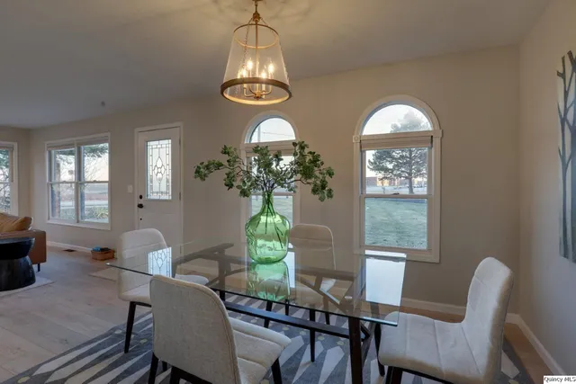 a view of a dining room with furniture and chandelier