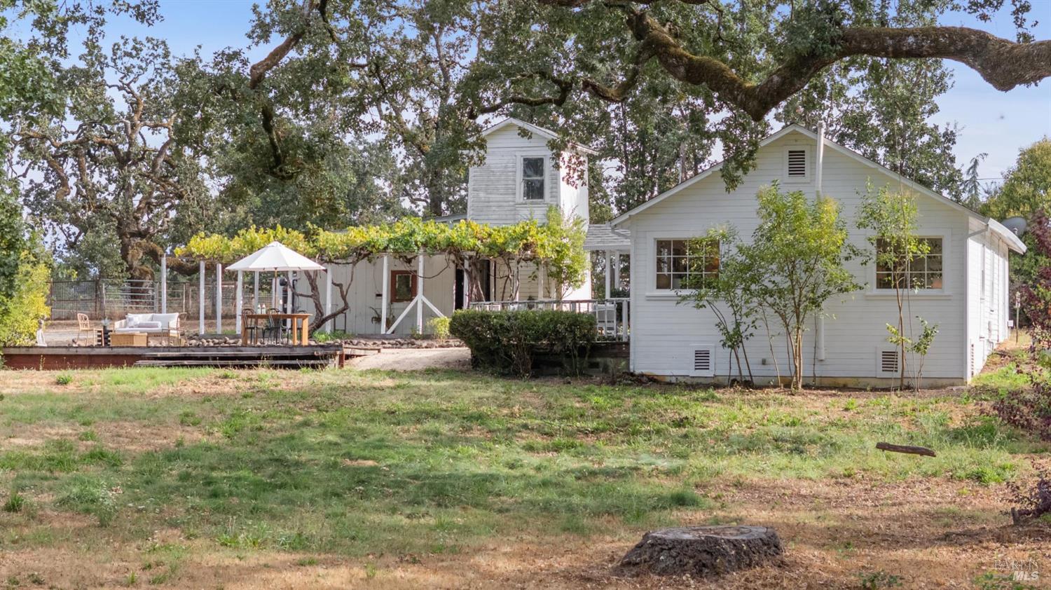 a view of a house with backyard and sitting area