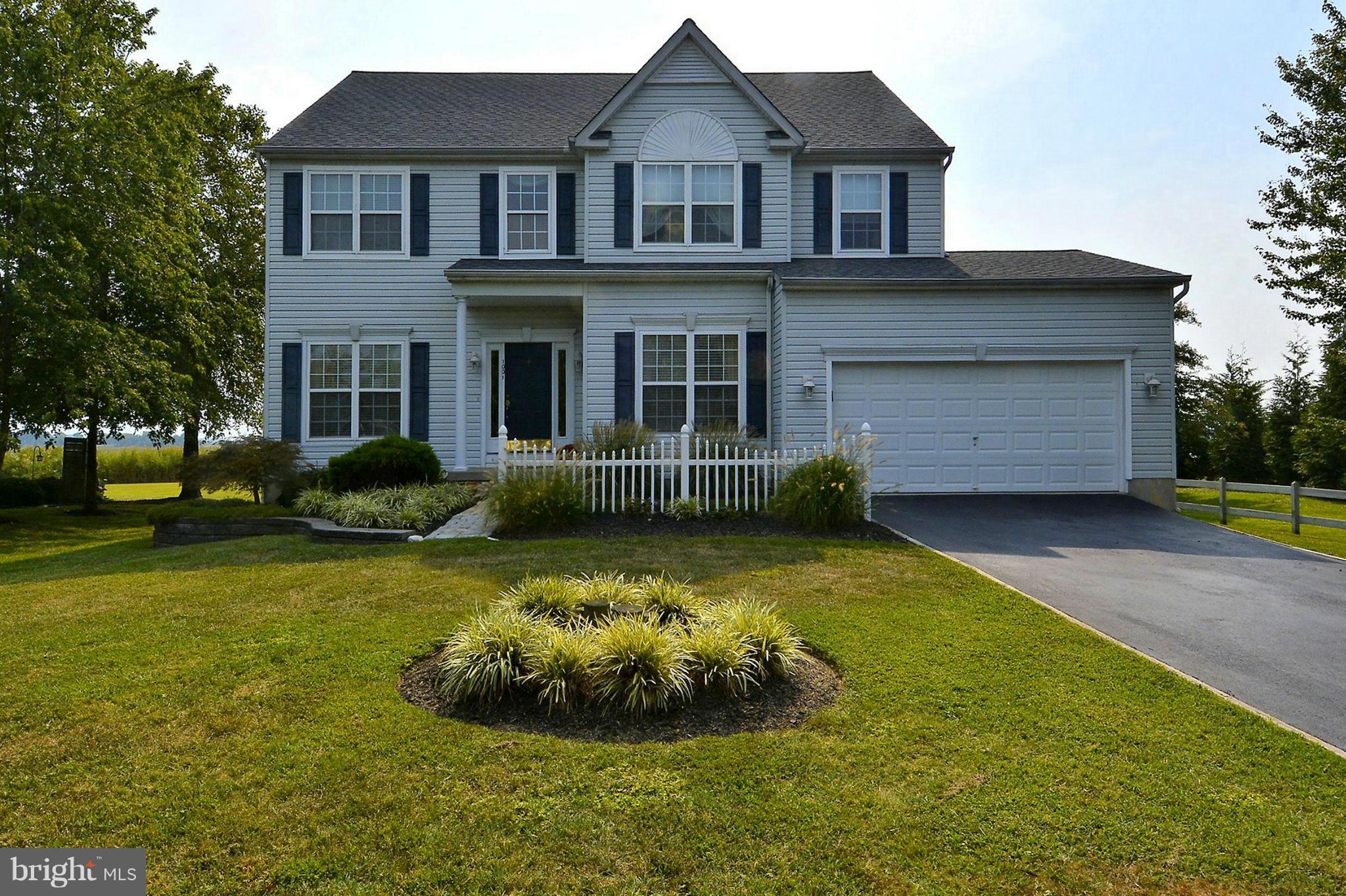1001 Long Point Road Grasonville, MD 21638 - Photo 2 of 29 a front view of a house with a garden and porch