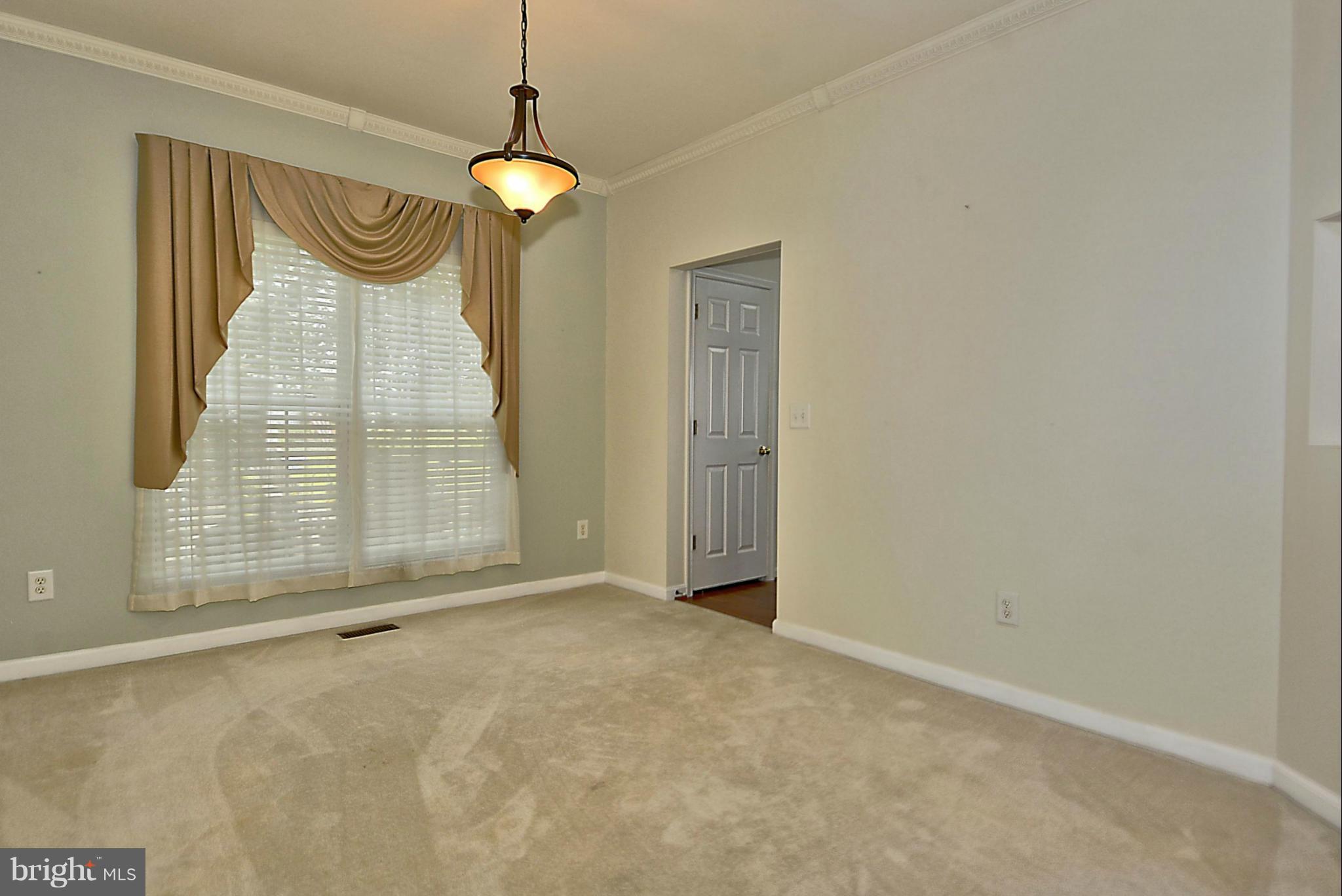 1001 Long Point Road Grasonville, MD 21638 - Photo 11 of 29 a view of an empty room with a fireplace and a window