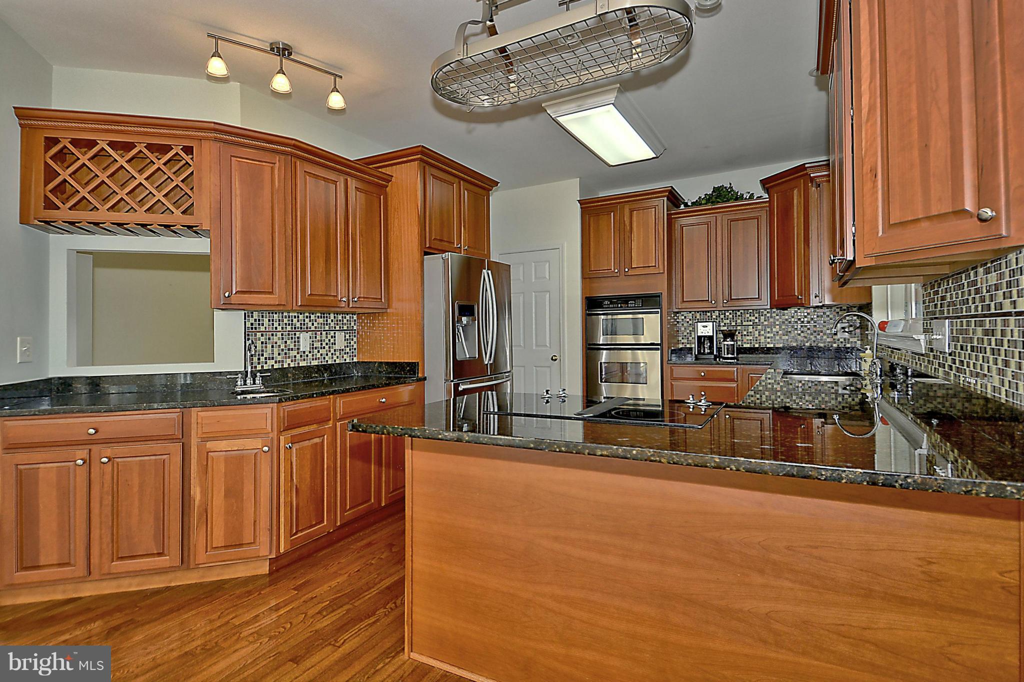 1001 Long Point Road Grasonville, MD 21638 - Photo 7 of 29 a kitchen with stainless steel appliances granite countertop a stove a sink and a refrigerator