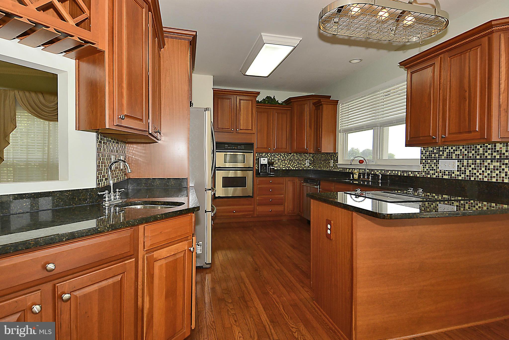 1001 Long Point Road Grasonville, MD 21638 - Photo 10 of 29 a kitchen with granite countertop a sink a counter top space and cabinets