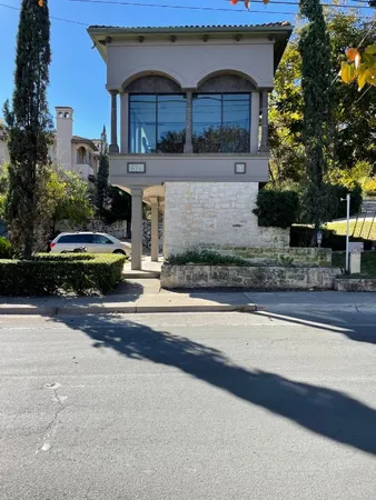 a front view of house with car parked