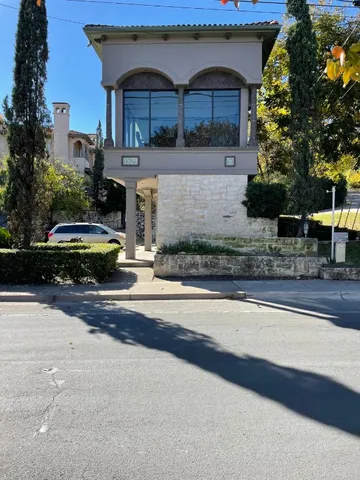 a front view of house with car parked