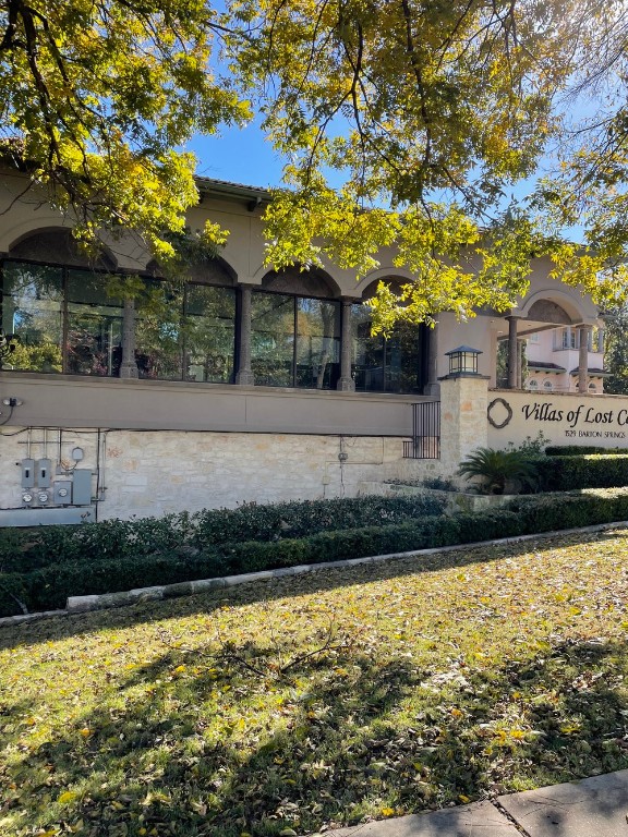1529 Barton Springs Road, Unit 31 Austin, TX 78704 - Photo 21 of 21 a front view of a house with a yard and a large tree