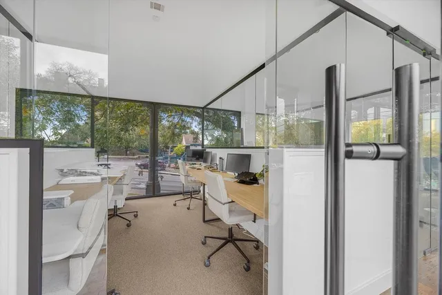 a view of a living room with a floor to ceiling window and floor to ceiling window